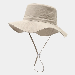 Detail of beige wide-brim sun hat with adjustable windproof rope and reinforced stitching