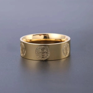 Detail shot of St. Benedict medal relief patterns on a vintage gold stainless steel ring