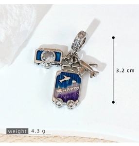 Macro detail of silver travel charms with camera, suitcase, and plane showing 3.2cm size