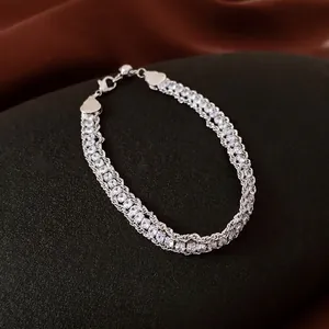 Luxury silver chain bracelet with pavé rhinestones and heart charms in a layered style