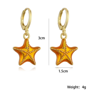 Detailed view of 18K gold plated starfish earrings with orange enamel, 3cm length and 4g weight