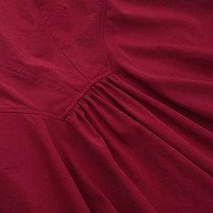 Detail view of deep red pleated fabric with professional double-needle stitching quality