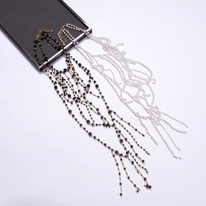 Elegant layered faux pearl and black beaded tassel body chain necklace in gold finish