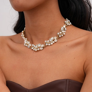 Detailed close-up of Baroque pearl and crystal vine necklace on a model