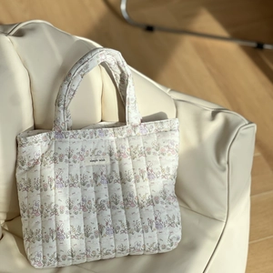 Quilted cotton tote bag featuring floral rabbit prints and simple wish label on a sofa