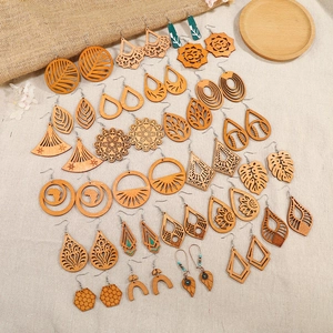 Collection of laser-cut wooden earrings with hollow geometric patterns and ethnic designs
