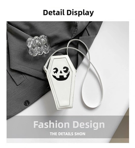 Close-up of white coffin-shaped PU leather crossbody bag with black pumpkin face print