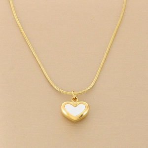 Detail of gold snake chain with a heart pendant featuring white enamel inlay