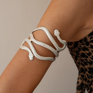 Detailed view of a silver double-headed snake arm cuff with textured metallic scales