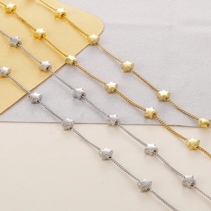 Detail of star-shaped eyewear chains in gold and silver finish with metallic luster