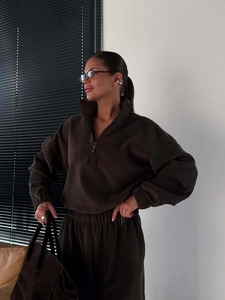 Close-up of chocolate polar fleece set featuring half-zip collar and elastic cuffs