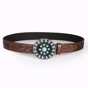 Detail of western retro belt showing floral embossed leather and turquoise metal buckle