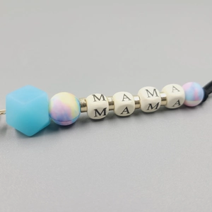 Macro shot of MAMA letter silicone beads and pastel marble spheres on a keychain