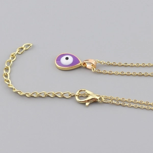 Detail of gold lobster clasp and extension chain on the purple evil eye necklace