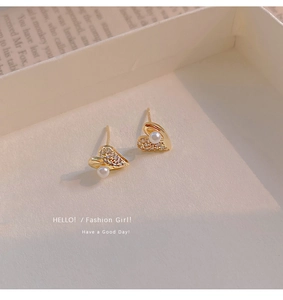 Detail of gold heart earrings with white pearls and micro-pave cubic zirconia crystals