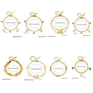 Gold plated stainless steel bracelet set with butterfly, heart and star charms on white background