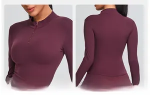 Detail of burgundy slim yoga top showing half-zipper collar and smooth back tailoring