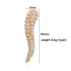 Detailed view of pearl drop earrings with 34mm length and 8.6mm width dimensions