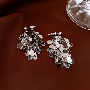 French vintage silver tassel earrings with zircon waterdrop sequins on brown velvet