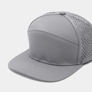 Detail of laser-cut perforations on grey five-panel flat brim breathable baseball cap