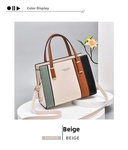 Detail of color-block tote bag with beige, green, and red panels on white pedestal