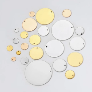 Flat lay of circular stainless steel blank tags in various sizes and metallic finishes