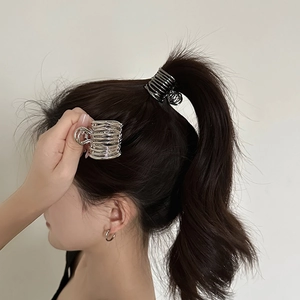 Minimalist metallic spiral hair clips in silver and black colors for high ponytail styling
