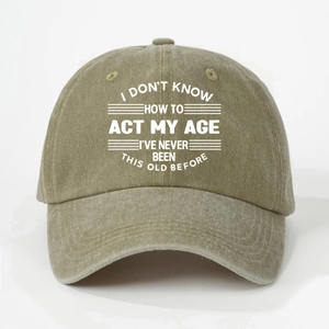 Detail of washed cotton baseball cap featuring vintage olive green fabric and humorous quote