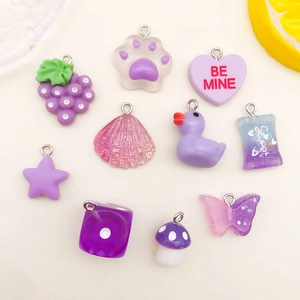 Collection of purple resin charms including grape, cat paw, and heart shapes for DIY jewelry