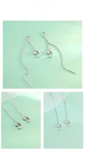 Detailed macro view of S925 sterling silver star and moon tassel chain earrings with crystals