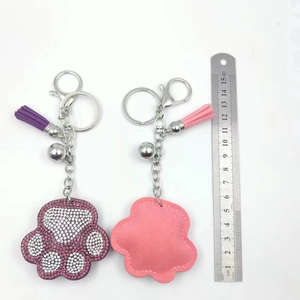 Sparkling rhinestone bear paw keychain with tassels and bells measuring 15cm long