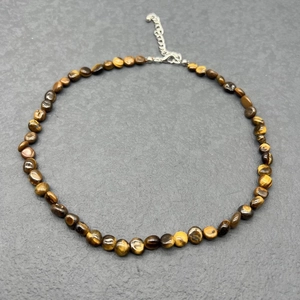 Close-up of tiger eye bead necklace with stainless steel lobster clasp and extension chain