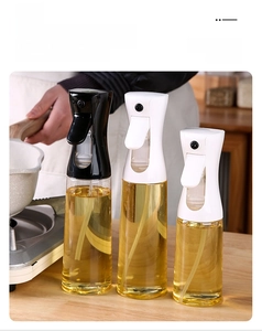 Detail of oil spray bottles with press heads and long straw tubes in a kitchen setting