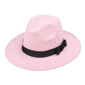Close-up of pink wool fedora hat featuring a wide black ribbon and side bow detail