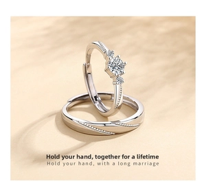 Detail of adjustable S925 sterling silver couple rings with engraving and zircon stones