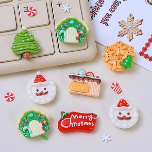 Christmas resin charms featuring Santa and tree shapes on a beige computer keyboard