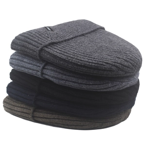 Detailed stack of ribbed knit wool beanies in gray, navy, black, and coffee for winter
