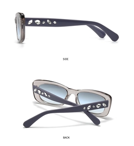 Detail view of square sunglasses with rhinestones and blue gradient lenses