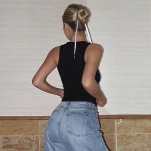 Rear view of black slim fit ribbed tank top showing precise tailoring and sleek fit