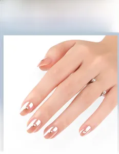 Detail of peach gold mirror almond nails with golden hearts and letter art designs