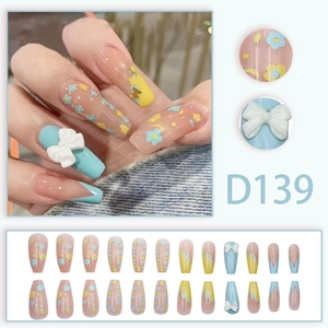 Long trapezoid blue press-on nails with floral patterns and 3D ribbon bow accents