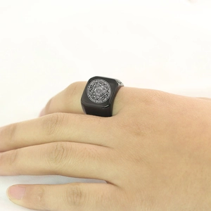 Detailed view of black square signet ring with engraved Seal of the Seven Archangels