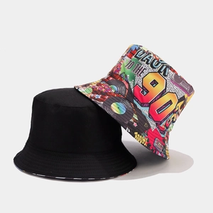 Detail of reversible bucket hat with 90s graffiti pattern and solid black side
