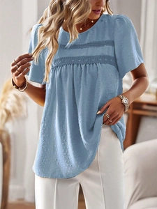 Detail of blue textured Swiss dot fabric and delicate lace trim on women's blouse
