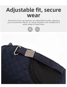 Detail view of the adjustable metal buckle and quilted stitching on the navy blue winter cap