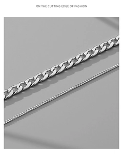 Detail of silver Cuban link chains showing layered thickness and metallic luster