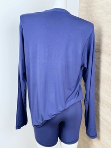 Rear view of navy blue long sleeve top and matching shorts on a mannequin