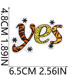 Detailed view of yes letter embroidery patch with leopard and tiger print patterns