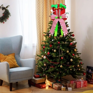 Christmas tree topper hat with elf legs and red striped bow on a festive tree