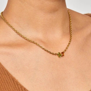 Minimalist 18k gold plated stainless steel necklace with green and orange zircons on model